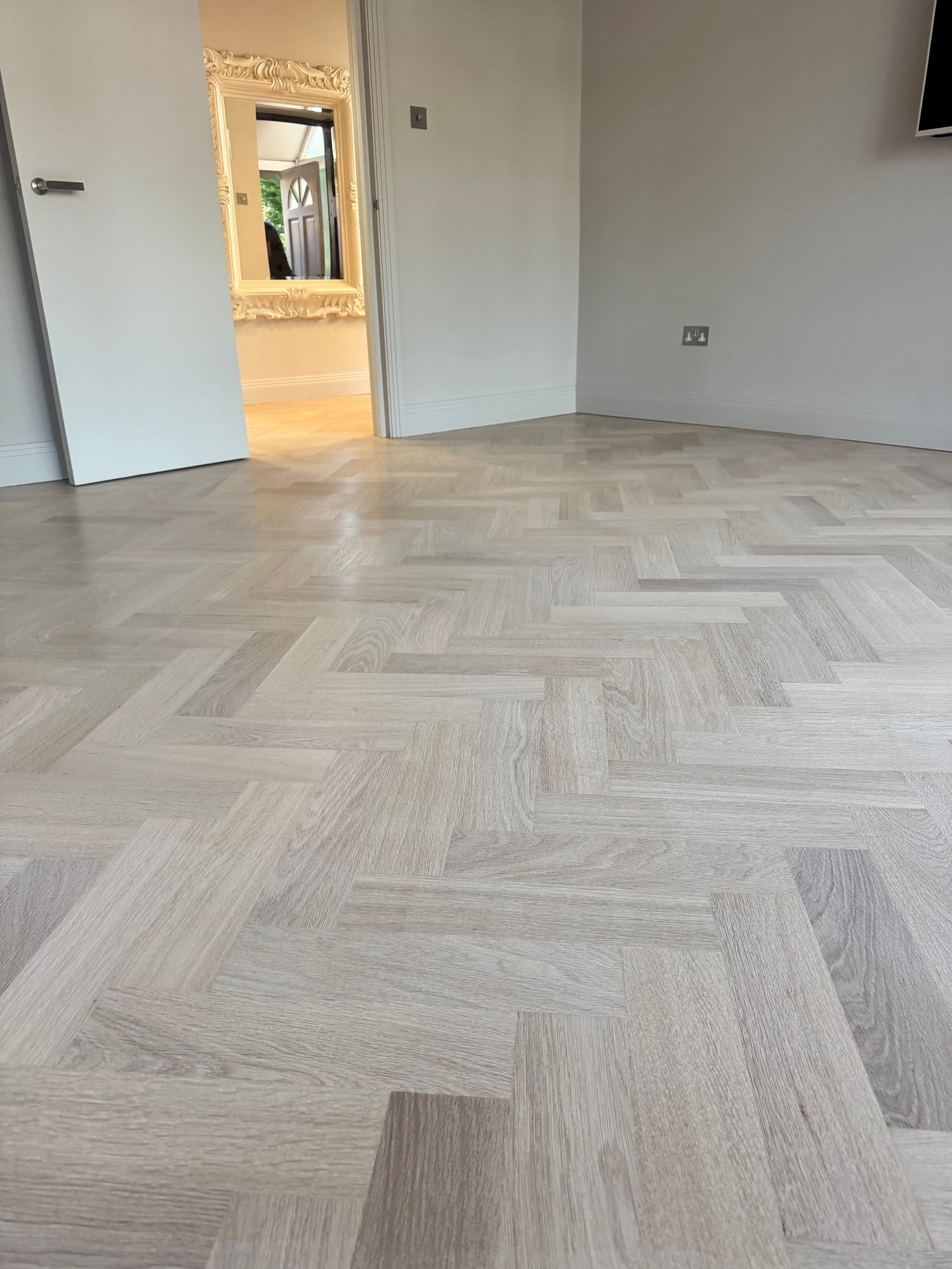 Whitewashed herringbone parquet in an Islington kitchen