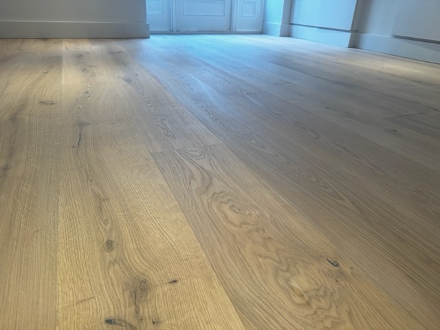 Refinished oak chevron parquet in a Barnes hallway
