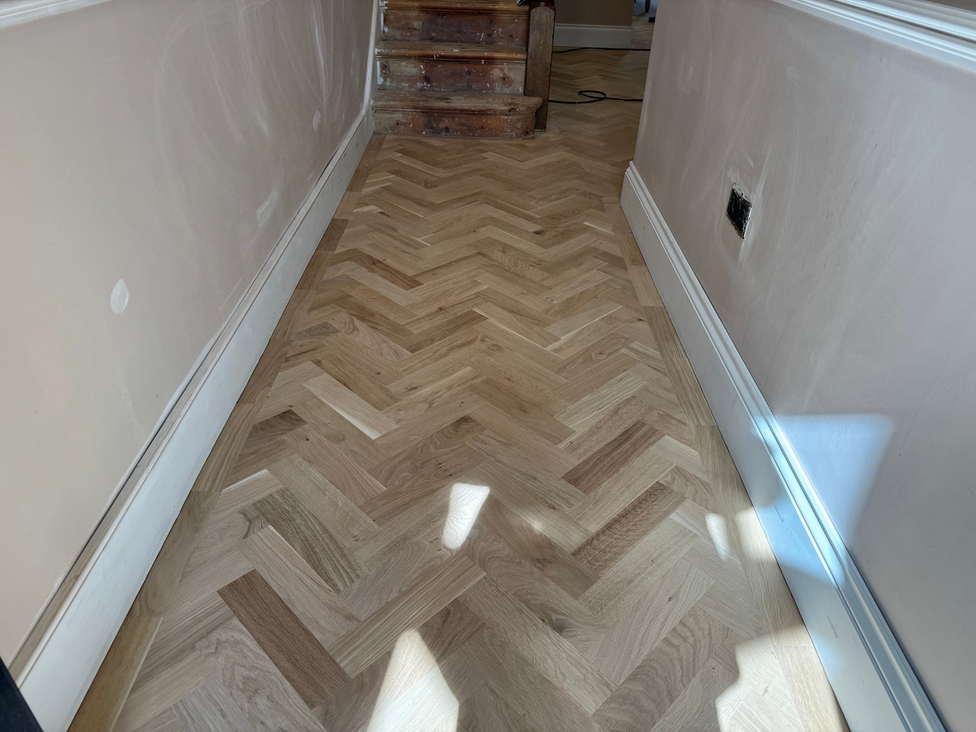 Oak chevron parquet in a hallway